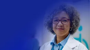 Female medical professional smiling confidently at the camera.