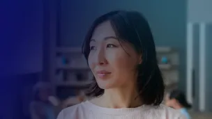 Female professional looking reflective, side profile.