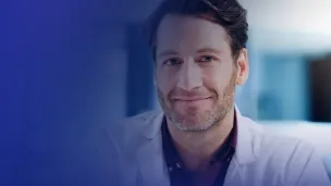 Male medical professional smiling at the camera.