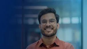 Male professional smiling at the camera.