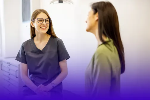 Female medical professional speaking with a female patient.
