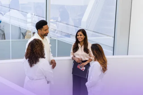 Team of four medical professionals in discussion.